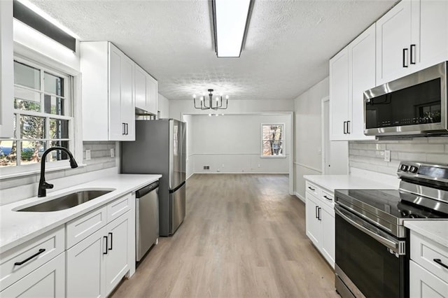 kitchen with white cabinetry, appliances with stainless steel finishes, and sink