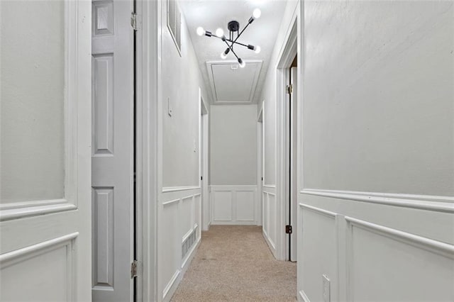 hallway featuring ornamental molding and light colored carpet