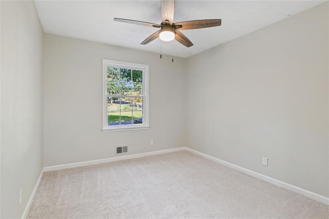 carpeted spare room featuring ceiling fan