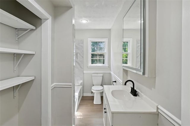 full bathroom featuring vanity, hardwood / wood-style floors, toilet, and shower / bathtub combination