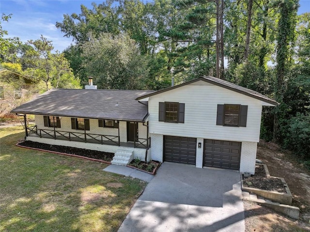 split level home featuring a garage, a front lawn, and a porch