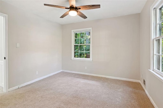 carpeted empty room featuring ceiling fan