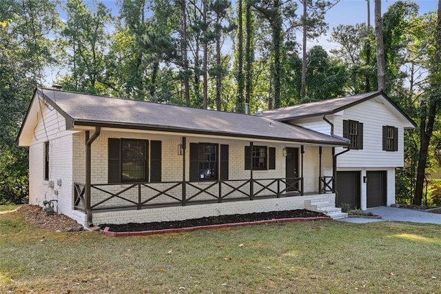 tri-level home featuring a porch, a garage, and a front lawn