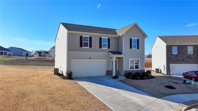 view of front of property featuring central AC unit and a garage