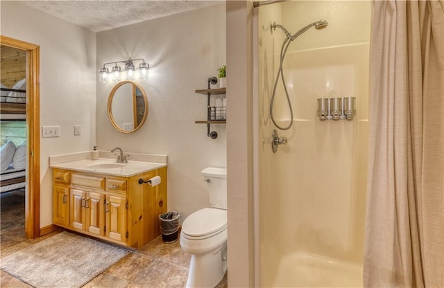 bathroom featuring toilet, a shower stall, a textured ceiling, and vanity