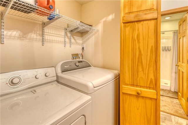 washroom featuring laundry area and separate washer and dryer