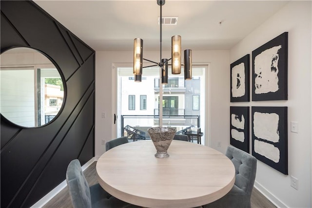 dining area featuring an inviting chandelier and dark hardwood / wood-style flooring