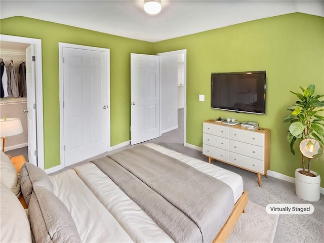 carpeted bedroom with vaulted ceiling