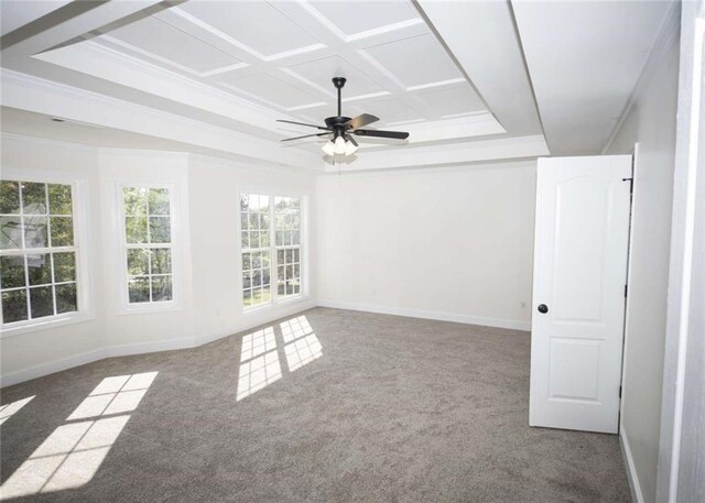 carpeted empty room with coffered ceiling, crown molding, baseboards, and a ceiling fan
