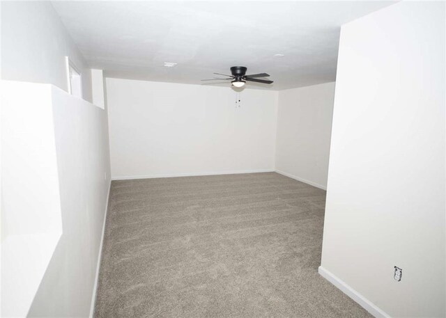 carpeted empty room with baseboards and ceiling fan