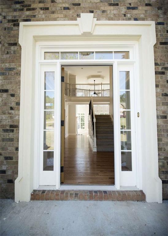view of exterior entry featuring brick siding