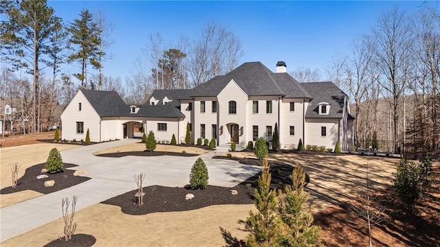 french country inspired facade featuring a chimney