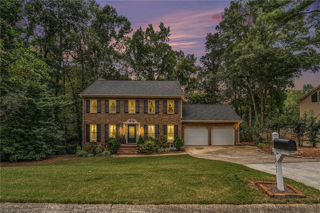 colonial-style house with a lawn and a garage