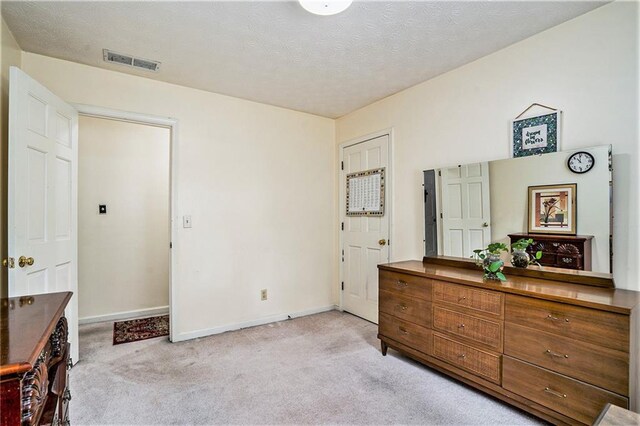 carpeted bedroom with a textured ceiling