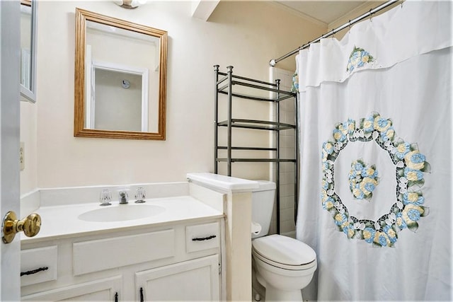 bathroom featuring ornamental molding, a shower with curtain, vanity, and toilet