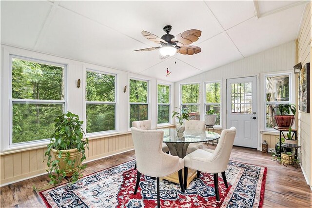 sunroom / solarium with ceiling fan, vaulted ceiling, and a healthy amount of sunlight