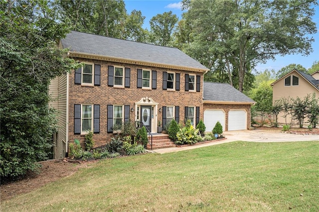 colonial-style house featuring a garage and a front lawn