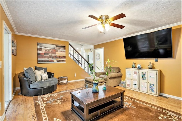 living room featuring a textured ceiling, hardwood / wood-style flooring, and crown molding