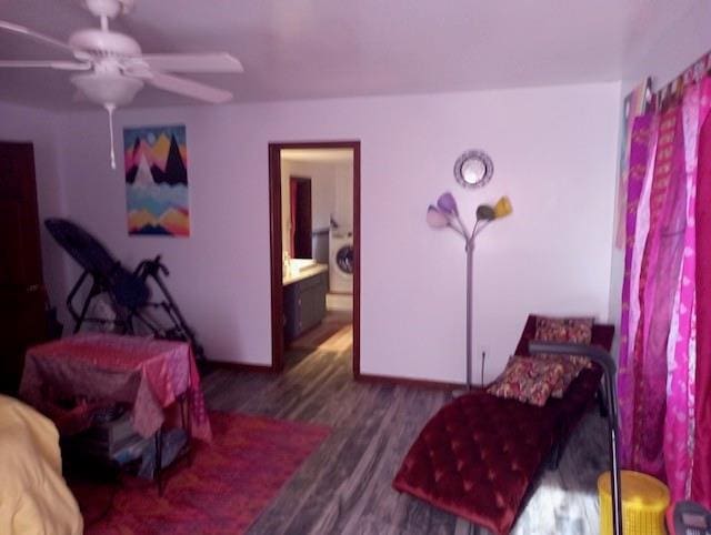 bedroom featuring washer / clothes dryer, ceiling fan, dark wood-type flooring, and ensuite bath