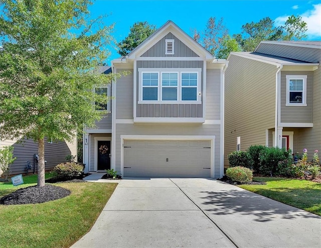 view of front of home with a front yard and a garage