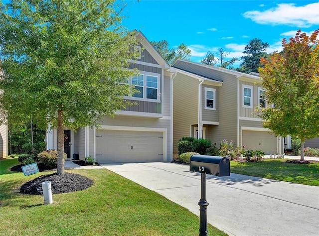 view of front of house featuring a front lawn and a garage