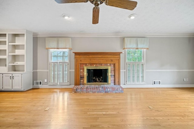 unfurnished living room with a fireplace, visible vents, light wood finished floors, and baseboards