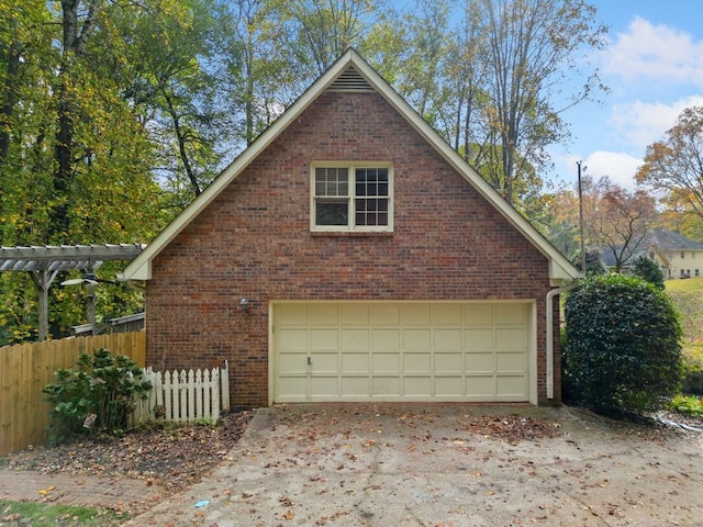 garage featuring a garage and fence