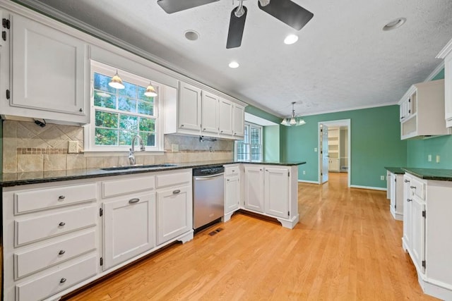 kitchen with a sink, white cabinetry, a peninsula, light wood finished floors, and dishwasher