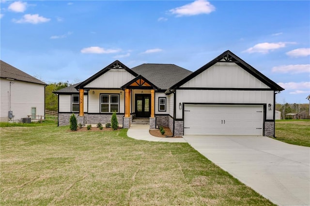 view of front of house with concrete driveway, an attached garage, stone siding, board and batten siding, and a front yard