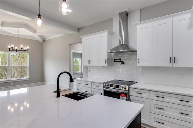 kitchen featuring beam ceiling, a sink, wall chimney exhaust hood, tasteful backsplash, and stainless steel range with electric stovetop