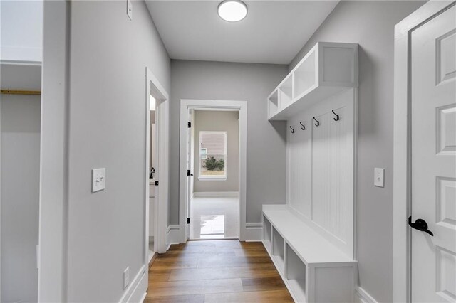 mudroom featuring baseboards and wood finished floors