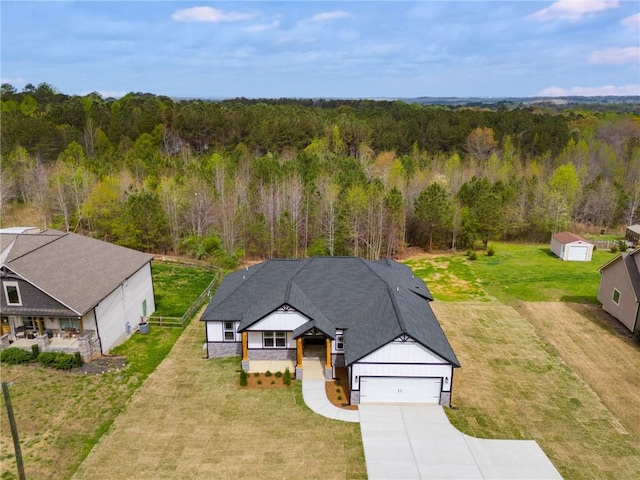 birds eye view of property with a forest view