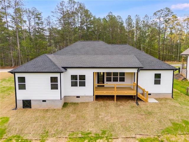 back of property with crawl space, roof with shingles, and a lawn