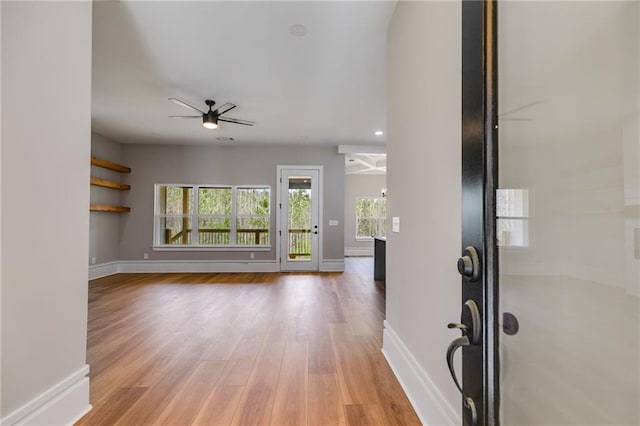 entrance foyer with baseboards, light wood-style flooring, and a ceiling fan