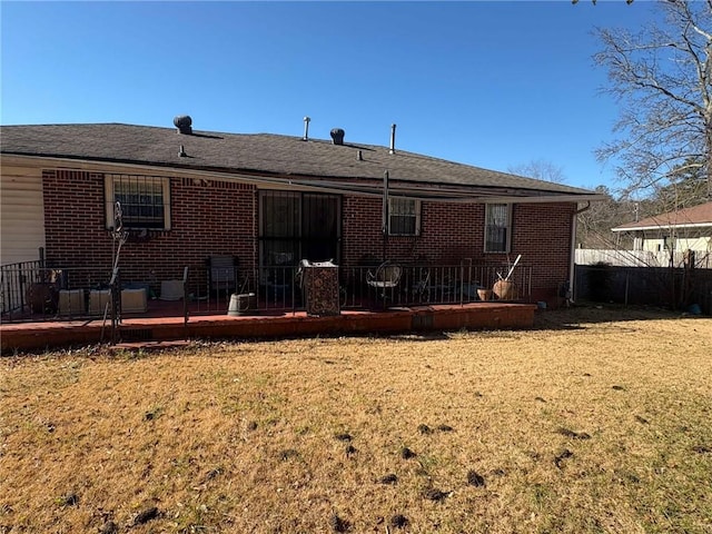 rear view of property with a yard and a deck