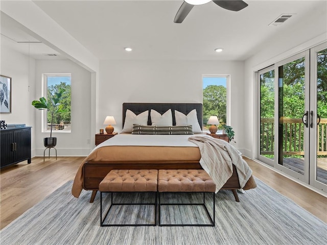 bedroom featuring recessed lighting, wood finished floors, visible vents, and access to exterior