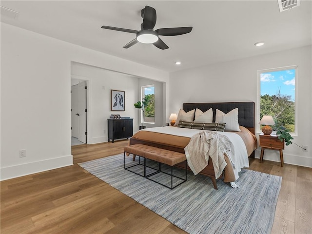 bedroom featuring light wood-type flooring, baseboards, visible vents, and recessed lighting