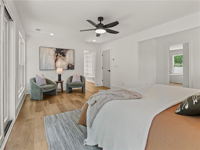 bedroom with baseboards, visible vents, a ceiling fan, light wood-style flooring, and recessed lighting