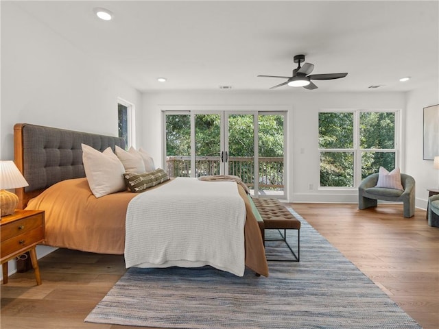 bedroom featuring recessed lighting, wood finished floors, a ceiling fan, baseboards, and access to exterior