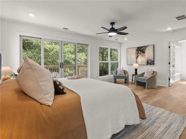 bedroom with access to outside, visible vents, wood finished floors, and recessed lighting