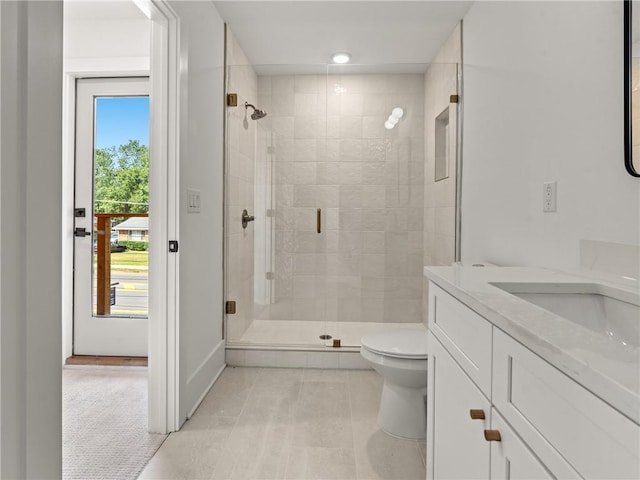 full bath with toilet, a stall shower, tile patterned flooring, and vanity