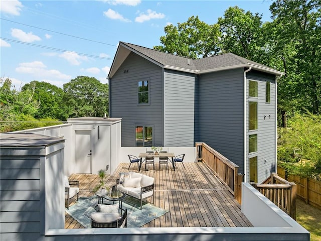 wooden deck featuring outdoor dining space and fence