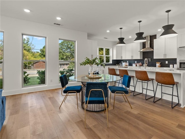 dining area featuring recessed lighting, visible vents, light wood-style flooring, and baseboards