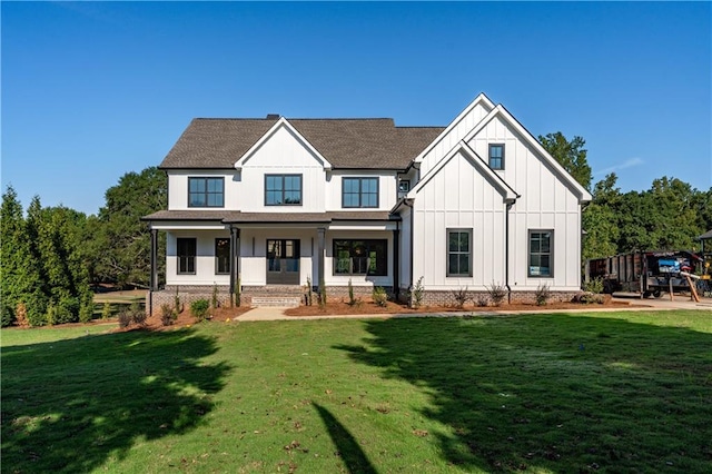 back of house with a lawn and a porch