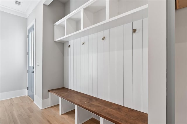 mudroom with light hardwood / wood-style flooring and crown molding