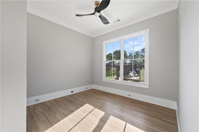 spare room featuring light wood-type flooring, ceiling fan, and crown molding