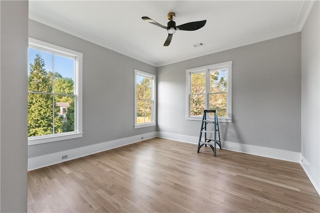 unfurnished room with plenty of natural light, ornamental molding, and ceiling fan