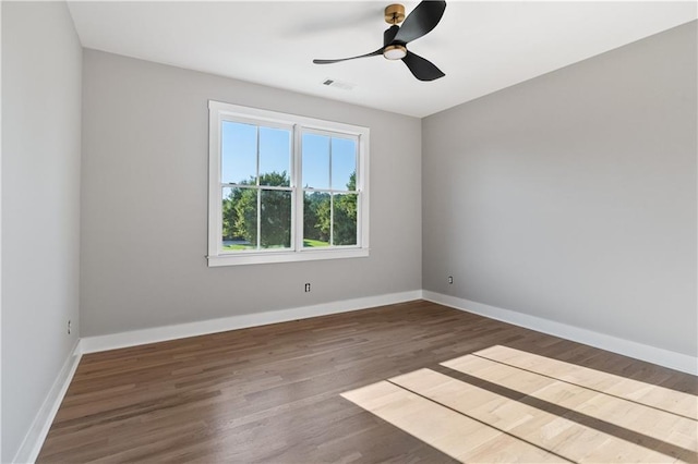 spare room featuring hardwood / wood-style floors and ceiling fan