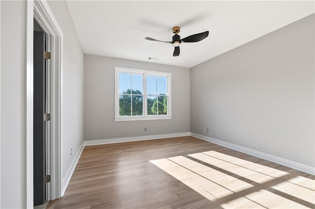 empty room with ceiling fan and light wood-type flooring