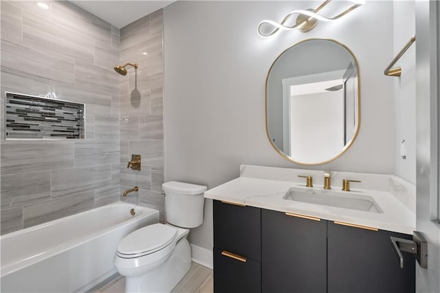 full bathroom featuring hardwood / wood-style floors, vanity, toilet, and tiled shower / bath